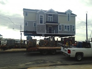 Contractors elevate a home at 10th Street and the bay. Properties above a specified 'base flood elevation' will pay far less in flood-insurance premiums under new legislation and knowing an existing property's elevation becomes increasingly important. Photo credit: John Ball