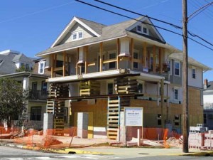 A home at the corner of Sixth Street and Central Avenue is being elevated above "base flood elevation" (BFE). Structures that remain below BFE face the steepest flood insurance premium increases.