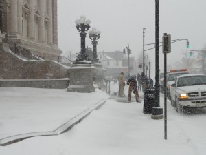 City workers shovel snow in front of City Hall in Ocean City on Monday morning.