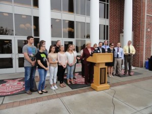 Students, teachers and administrators involved in the Student Spaceflight Experiments Program (SSEP), including Superintendent Kathleen Taylor (at podium) and Board of Education President Joe Clark (to her left), talk about the rocket that exploded Tuesday in Virginia.