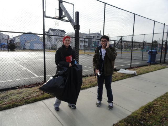 Lia Palapanis, vice president of the Ocean City High School Key Club, and Minh Vu, a National Honor Society member, work at the 15th Street Playground.