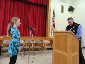 Chanon Styer correctly spells a word read by Ocean City Intermediate School Principal Geoffrey Haines on her way to a victory in a local spelling bee.