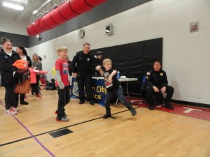 The Ocean City Police Department's Michael Gray clocks the speed of a pitch at the PTA Spring Carnival.