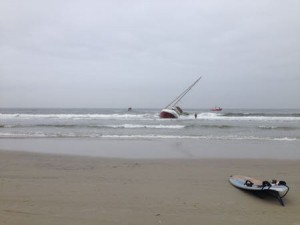 A TowBoat U.S. crew member delivered the tow line by paddling a sailboard out from the beach to his company's tow boats.