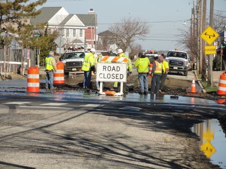 Crews work to repair a water main break at the intersection of North Street and Station Road.