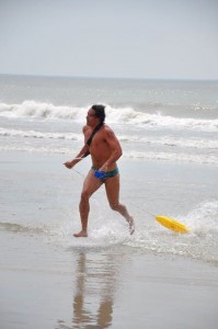 Quinn Cassidy runs to the finish as winner of Saturday's ocean swim during the 2015 Ocean City Beach Patrol tryout this weekend. Credit: Anne Copeland Merrill