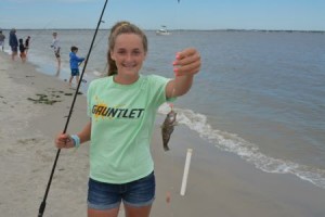 026: Maddi Koury, 13, of Chester Springs PA, holds up one of the 21 sea bass she caught to win a custom-made rod at the 40th annual Boys and Girls Surf Fishing Tournament.