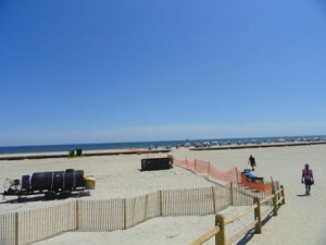 An orange fence marks the boundary of a crowded beach at 52nd Street and a project area at 51st Street waiting for new sand (left).