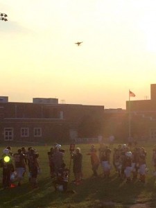 A drone flying close to the field interrupts a football scrimmage between Ocean City High School and Middle Township High School on Monday, Aug. 24. Credit: Heidi Alfano-Kern