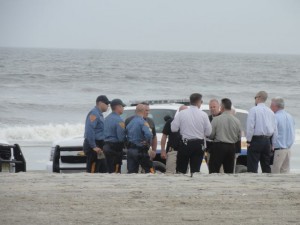 Authorities surround the woman's body on the beach at 57th Street on Tuesday, Sept. 29.