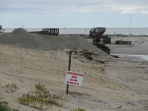 Sand starts to cover the 59th Street jetty at the southern terminus of the south end beach replenishment project.