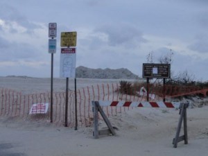 The beach entrances at 59th Street remain closed on Tuesday as crews wait for a break in the northeast swell to resume work.