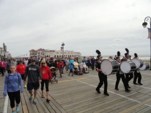 The Ocean City High School marching band leads the way with a couple hundred walkers following on a windy Saturday morning in Ocean City during the Walk for the Wounded.
