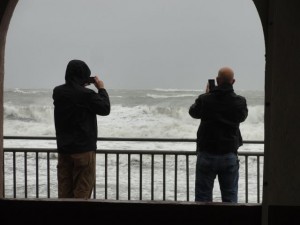 The Ocean City Music Pier offered a little shelter for onlookers taking in the power of the surf during a continuing northeast gale in Ocean City on Saturday, Oct. 3, 2015.