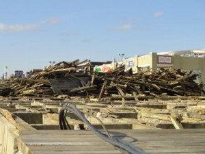 A scrap heap and a small section of decking near Seventh Street are all that remain before work crews can begin demolishing the boardwalk substructure between Plaza Place and Eighth Street.