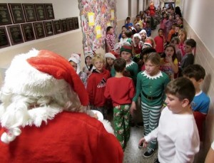 Students greeted Santa who arrived at the holiday party via police car. 