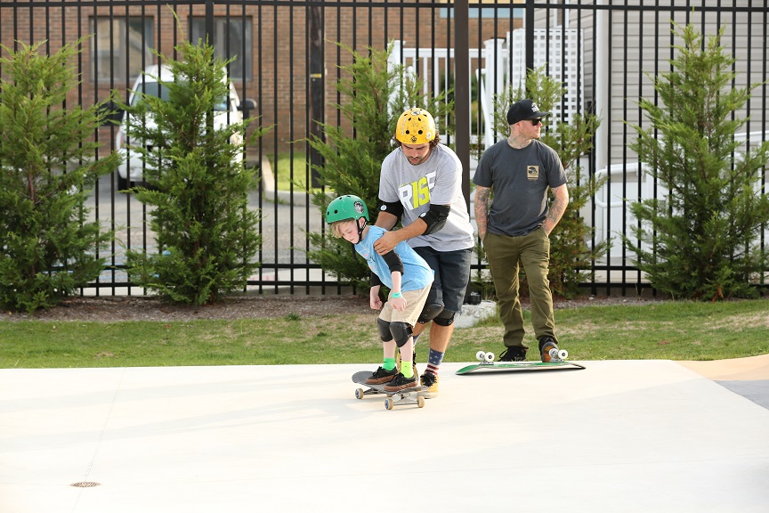 A beginner skateboarder receives some tips on the basics at the FCA Skate Camp.