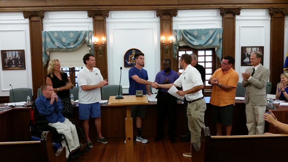 Ocean City High School star baseball player Sean Mooney, center, receives congratulations from members of City Council for compiling more wins, 26, than any other pitcher in city history. 