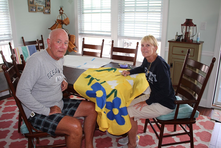 Mike Moran with wife Pam, working on one of her flag creations.