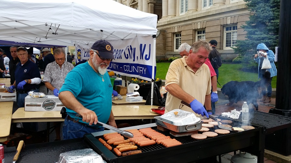 Carlo Calle, left, and Brandan Dierolf, of the Ocean City Exchange Club, cooked up some hotdogs and hamburgers on a grill.
