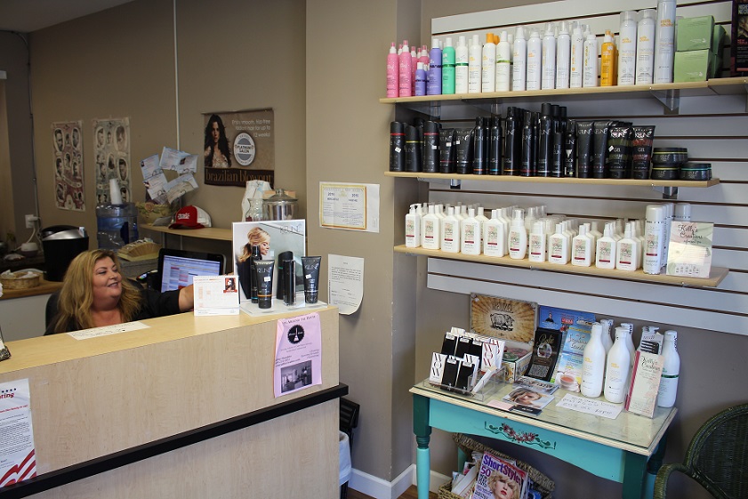 Kelly's Creations offers its own complete line of hair care products, as receptionist Helen Helth points out. 