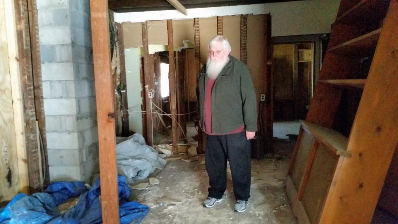 John Loeper, chairman of the nonprofit organization overseeing the renovations, stands in what is now the building's gutted interior. 