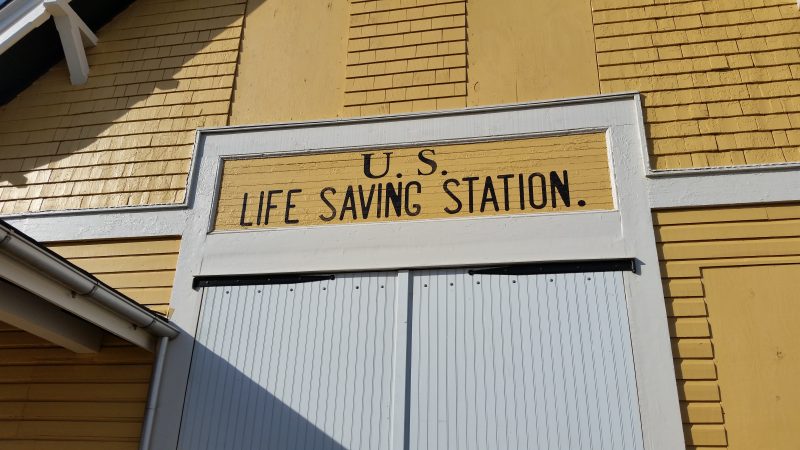 The words "U.S. Life Saving Station" are painted in big, black letters on the building's oceanside.