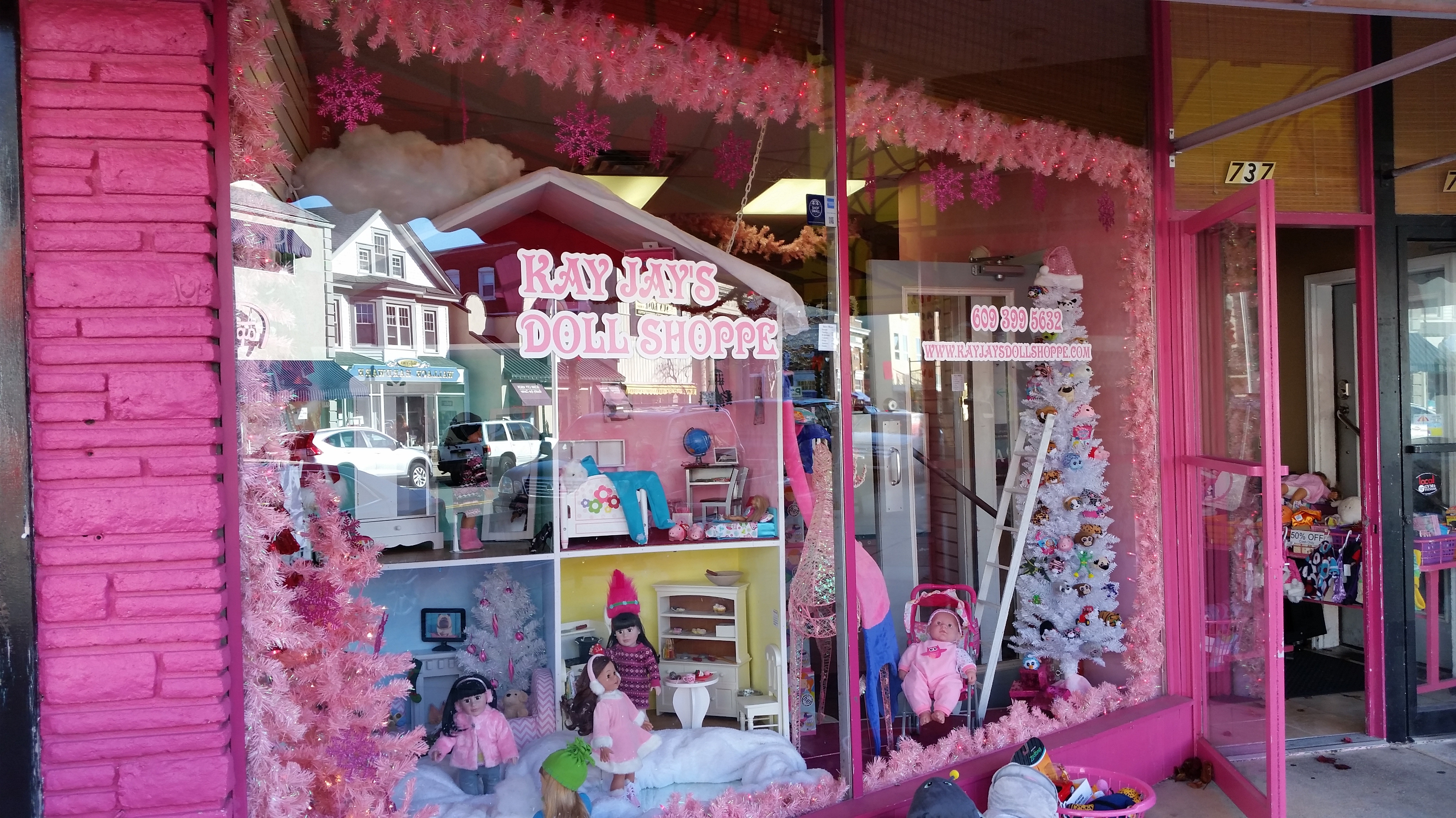 The storefront is part of the pink-dominated color scheme.