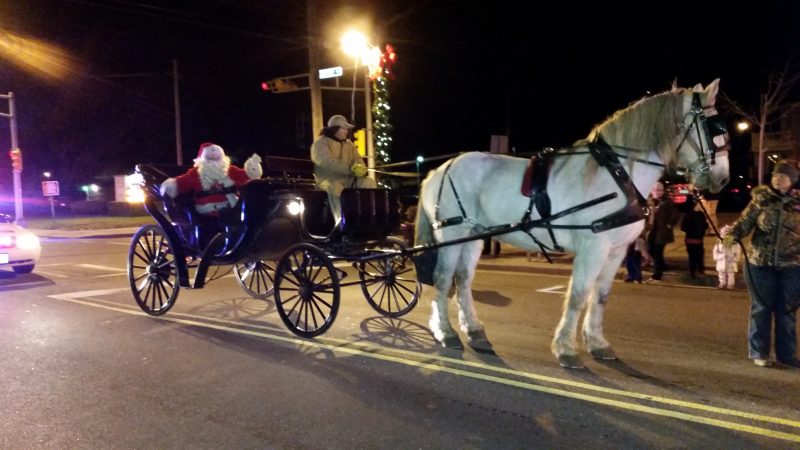 A big white horse pulled Santa down Asbury Avenue in a carriage.