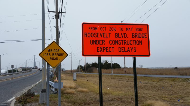 A sign on the approach to the bridge warns commuters to expect delays.