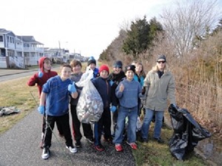A group including (not in order) Aodhan Daly and his mom, Mary Daly (right), Bridget Dougherty, Sierra Ortiz, Brett Oves, Zachary and Sean Mazzitelli, Ricky Urban, Race Meyers and Justin Bush clean near the Howard S. Stainton Wildlife Refuge in Ocean City, NJ, during the annual Martin Luther King Day of Service in 2015.