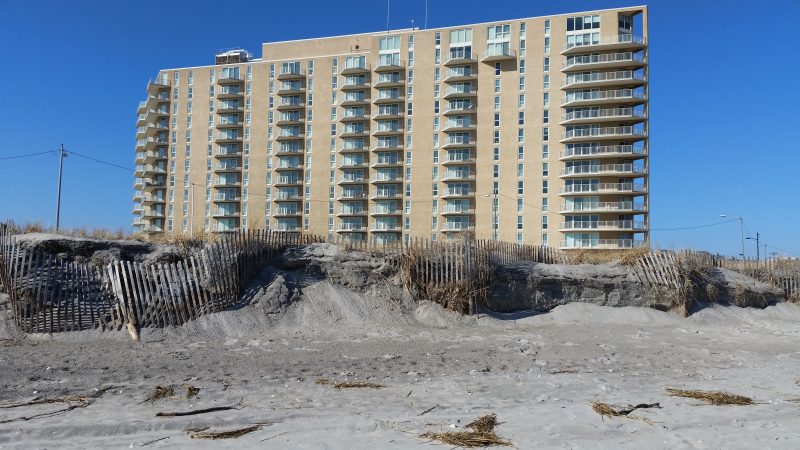 Part of the dunes have been sheared away right up to the fence line in front of the Gardens Plaza condominium near Third Street.