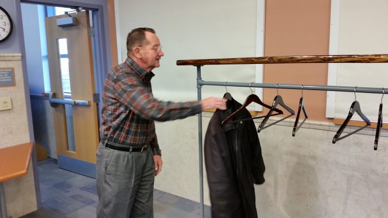 Tom Weber, a neighbor of the Leonetti family, has the honor of being the first one to hang his coat on the rack.