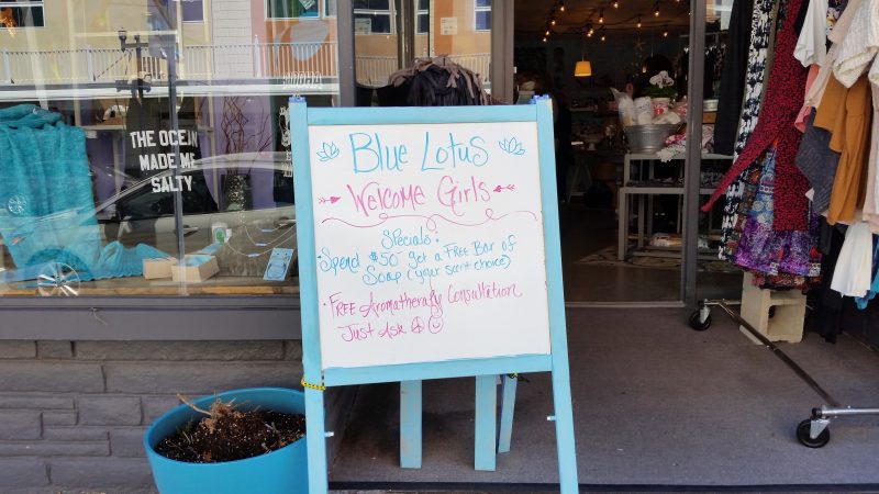 A sign outside the Blue Lotus boutique on Asbury Avenue says "Welcome Girls."