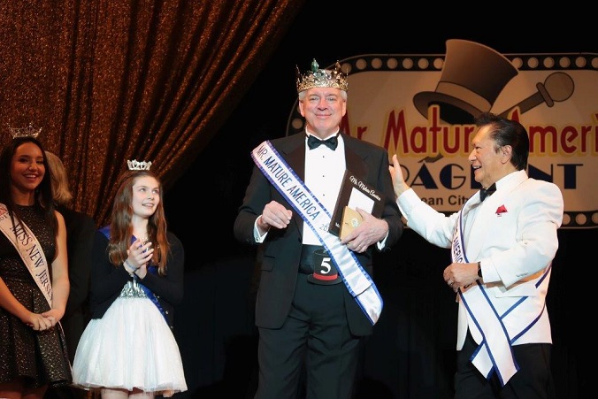 Mr. Mature America 2017 Matthew Allen accepts the crown from Rene Sese, Mr. Mature America 2016.